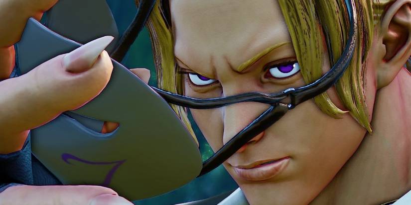 Close up of Bega taking off his mask in Street Fighter