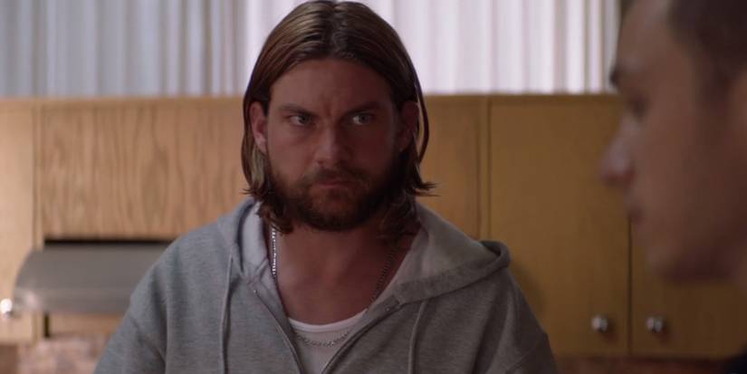 Deran Cody (Jake Weary) looks at J Cody (Finn Cole) in family meeting in TNT's Animal Kingdom