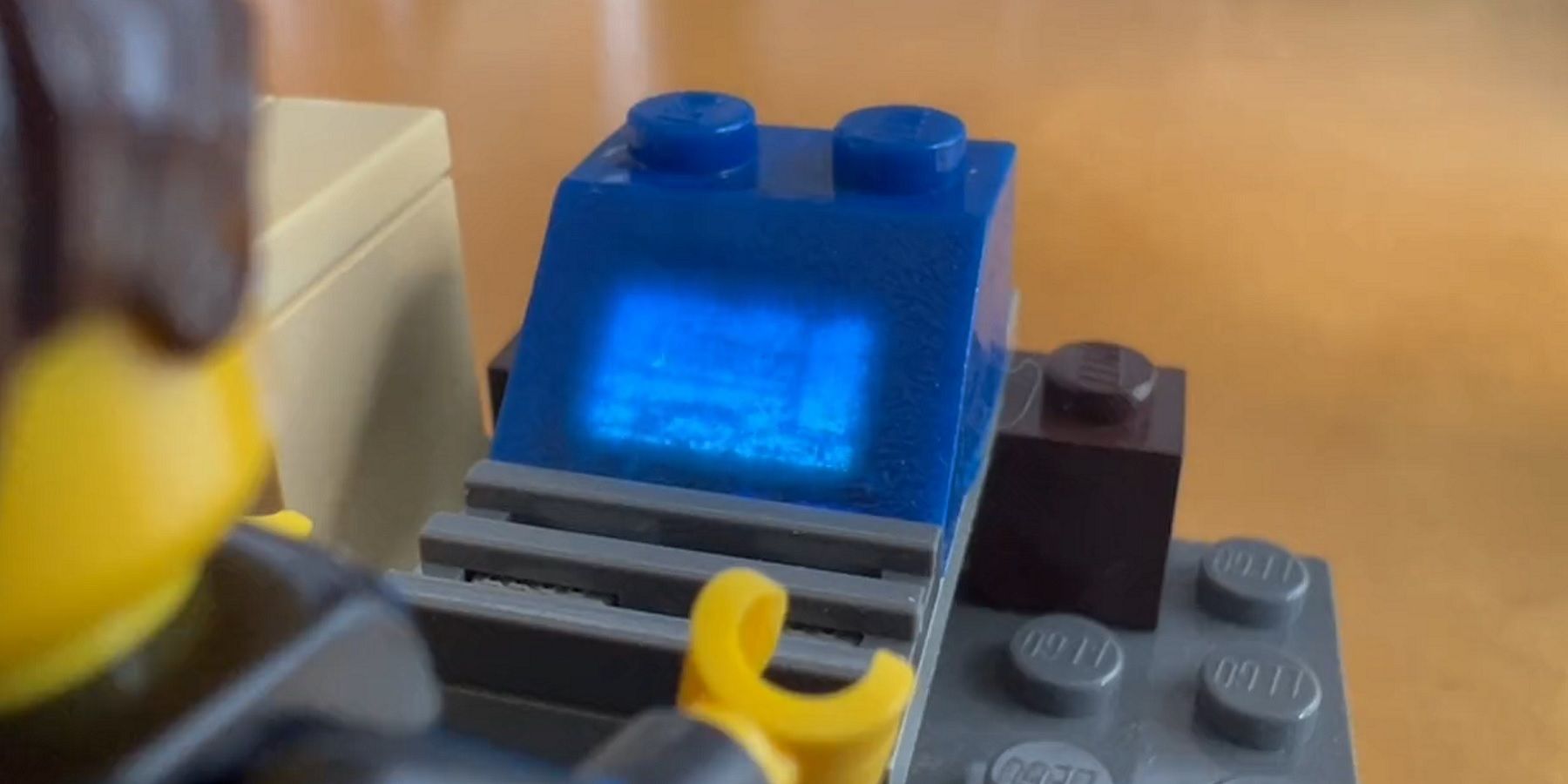Close-up image of a LEGO brick which is showing a blurry version of Doom.