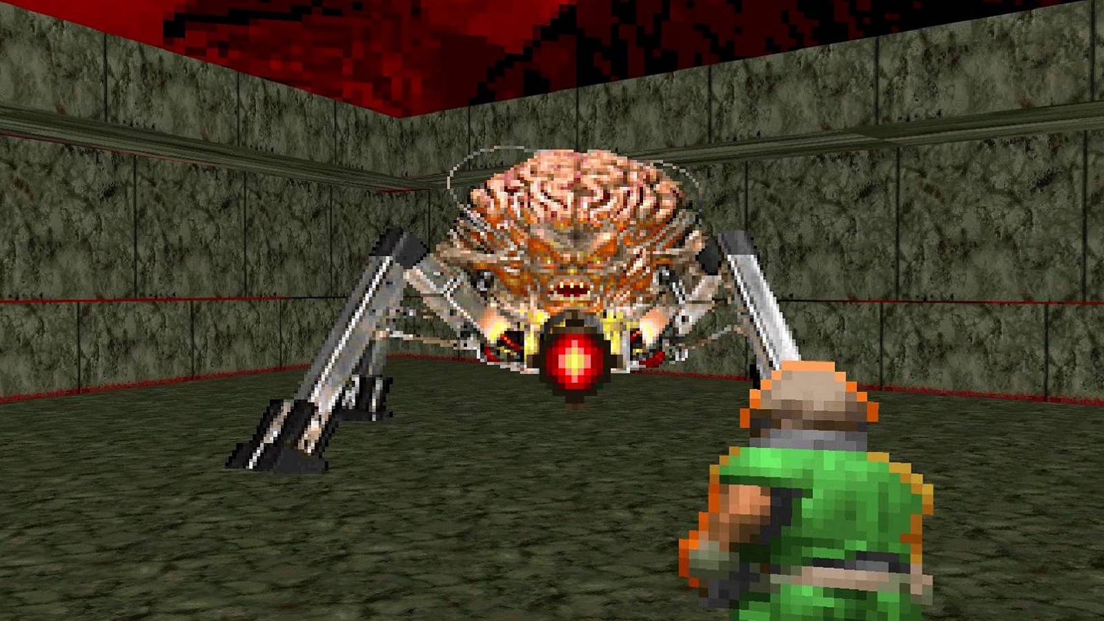 Screenshot from Doom showing the Doomguy fighting the Spider Mastermind.