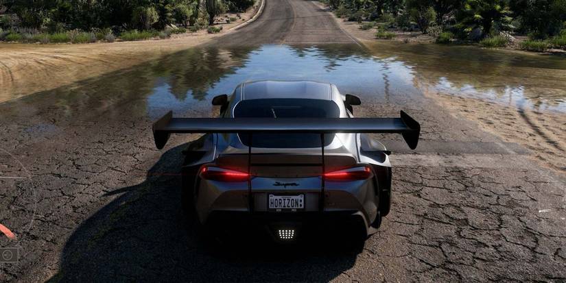 forza horizon 5 car a road with a puddle infront 