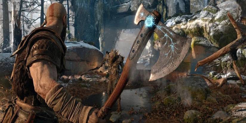 god of war kratos using his axe 