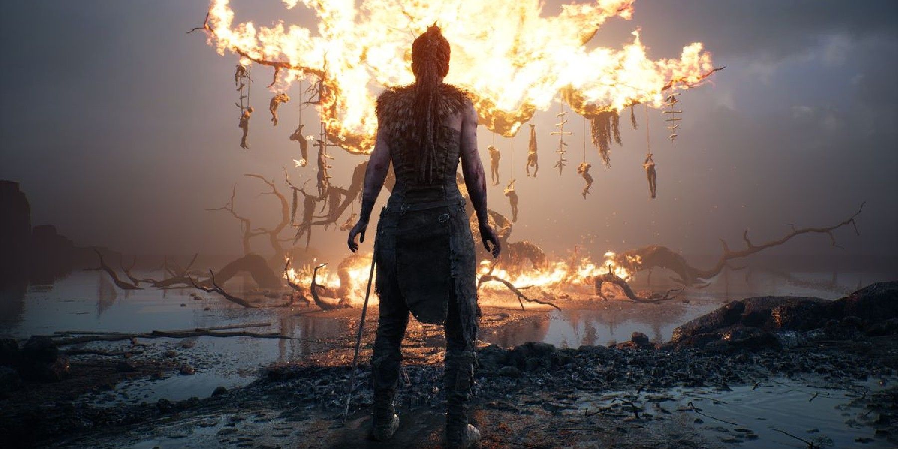 Senua facing a burning tree in Hellblade Senua's Sacrifice