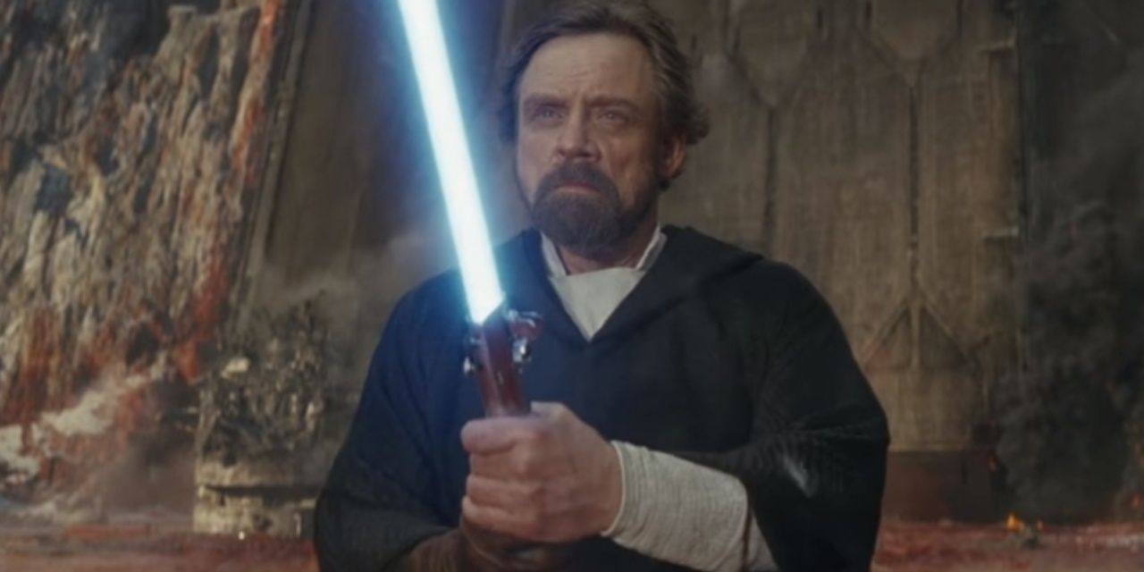 old luke skywalker with his father's lightsaber