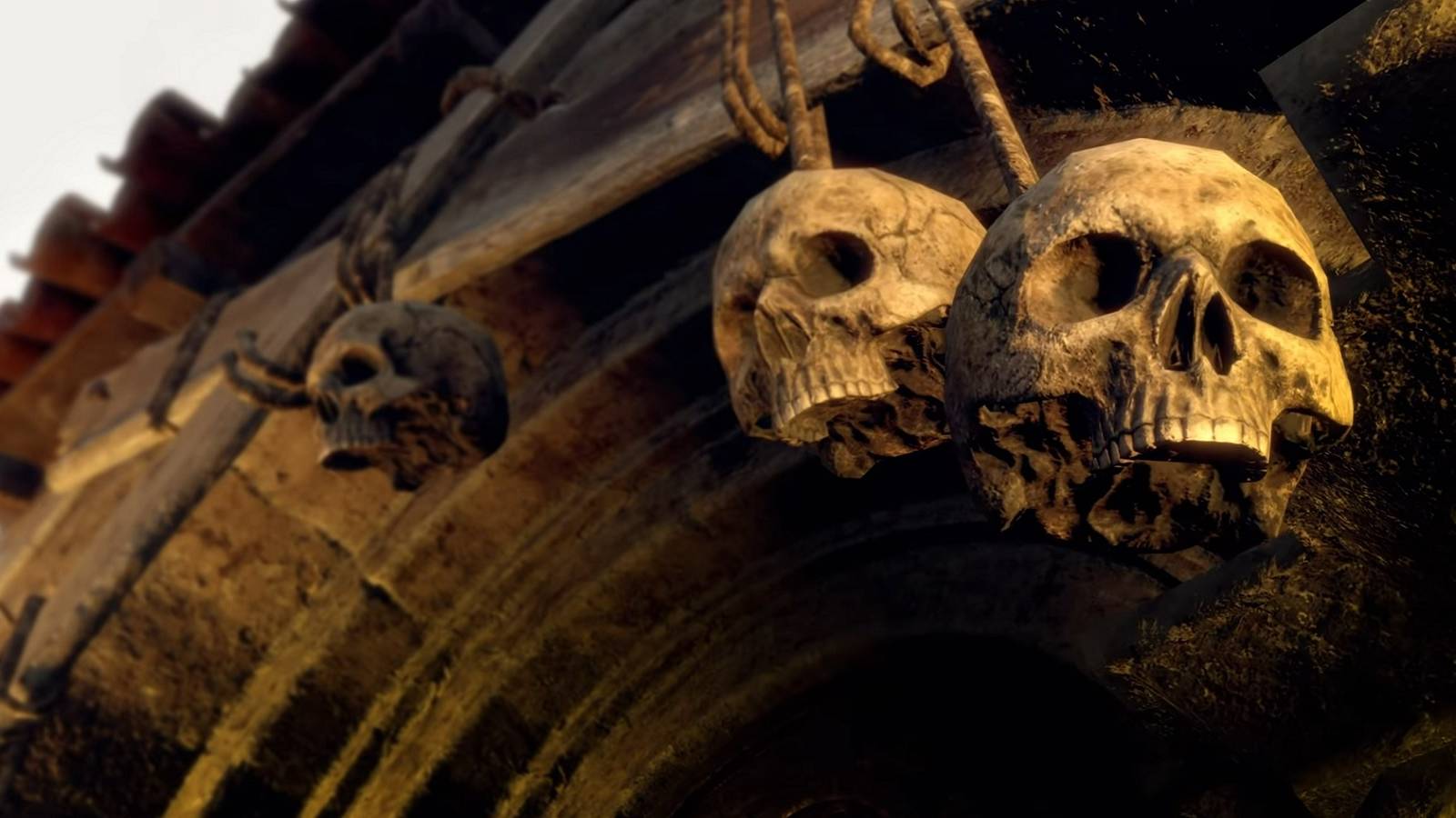 Image from the Resident Evil 4 Remake trailer showing two hanging skulls.