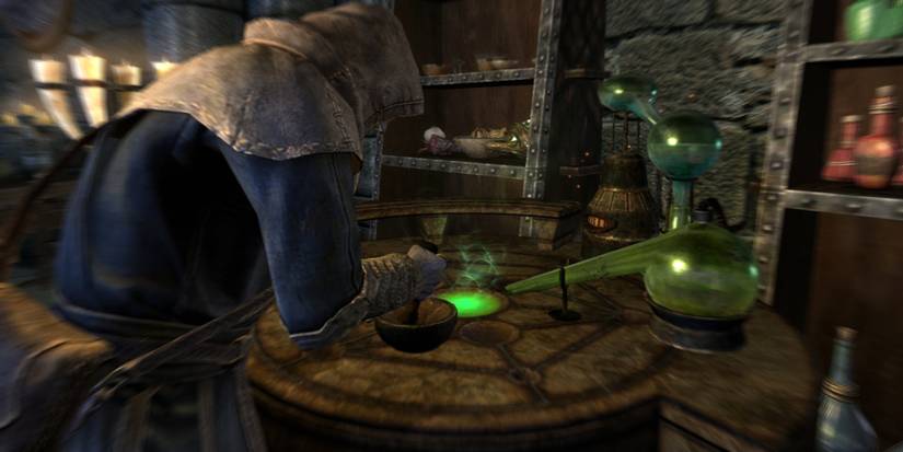 A mage creating something on an alchemy table in Skyrim