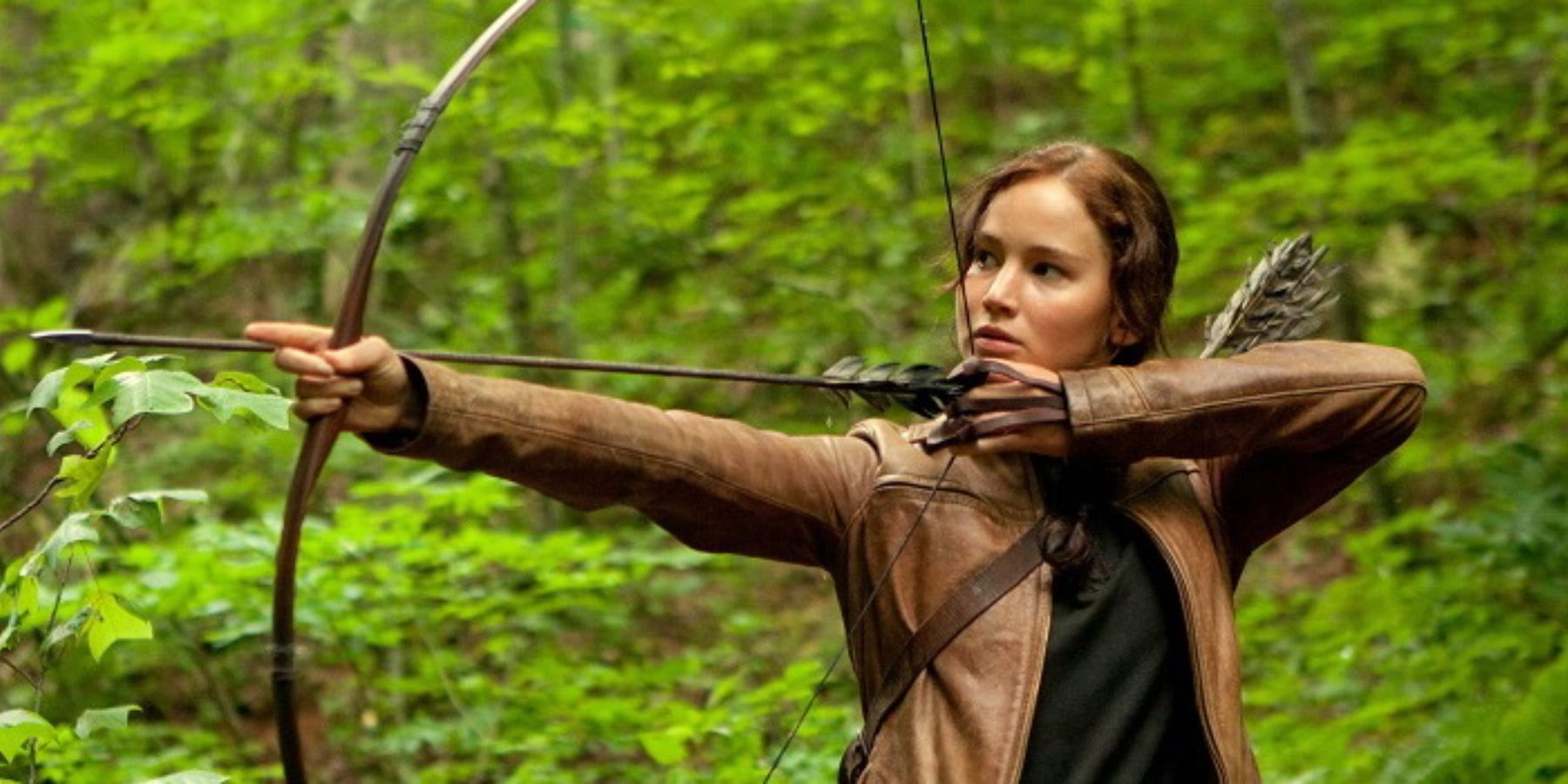 Jennifer Lawrence as Katniss Everdeen holding a bow in The Hunger Games
