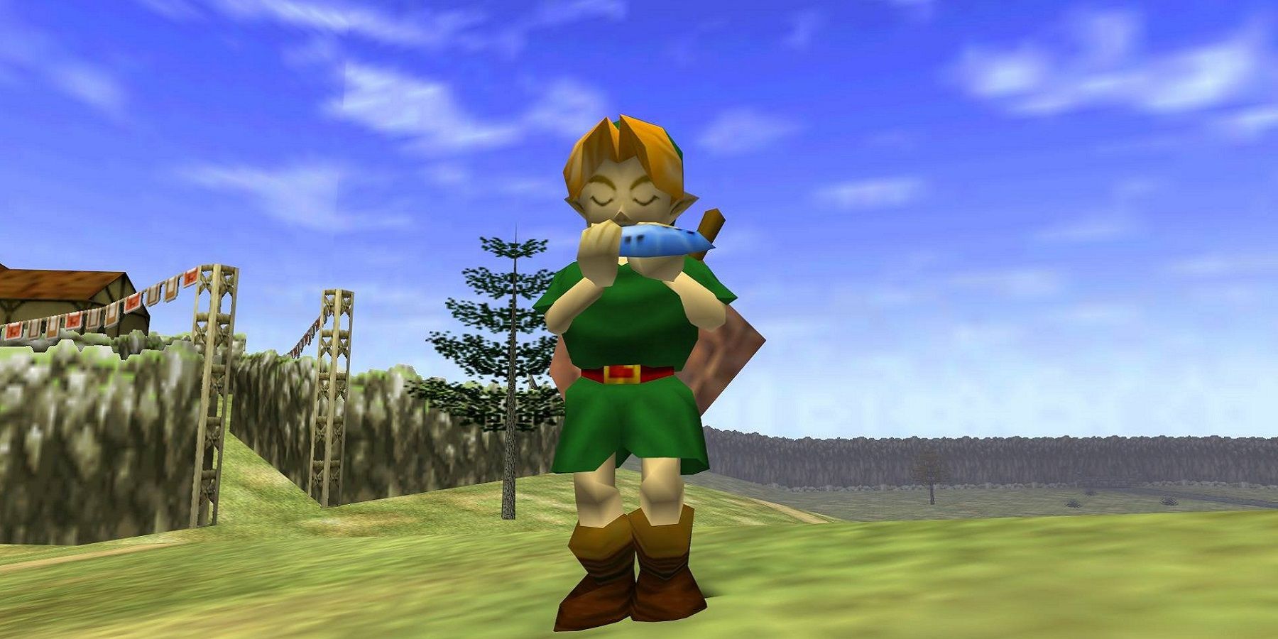 Image from The Legend of Zelda: Ocarina of Time showing Link playing the titular ocarina in a field.