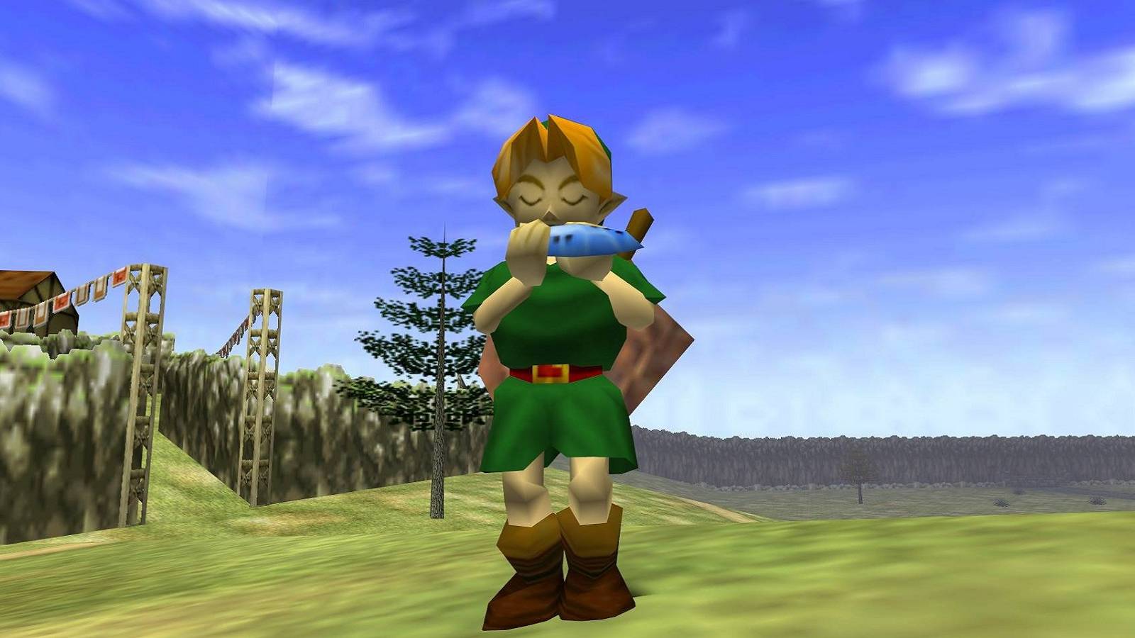 Image from The Legend of Zelda: Ocarina of Time showing Link playing the titular ocarina in a field.