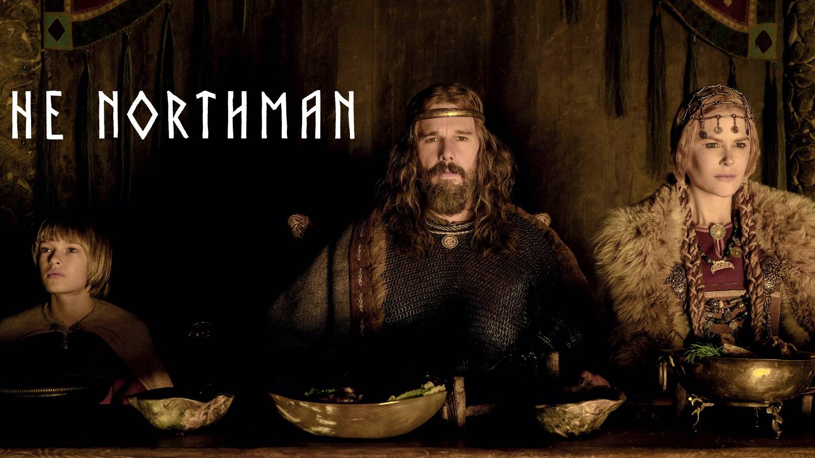 Amleth (Oscar Novak), King Aurvandill (Ethan Hawke), and Queen Gudrún (Nicole Kidman) feast in The Northman
