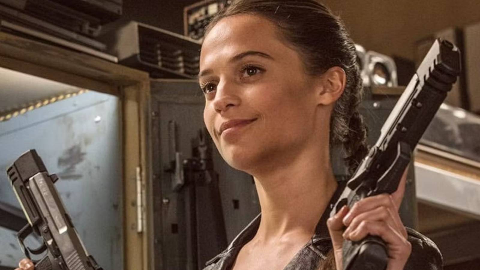 Alicia Vikander holding guns as Lara Croft Tomb Raider