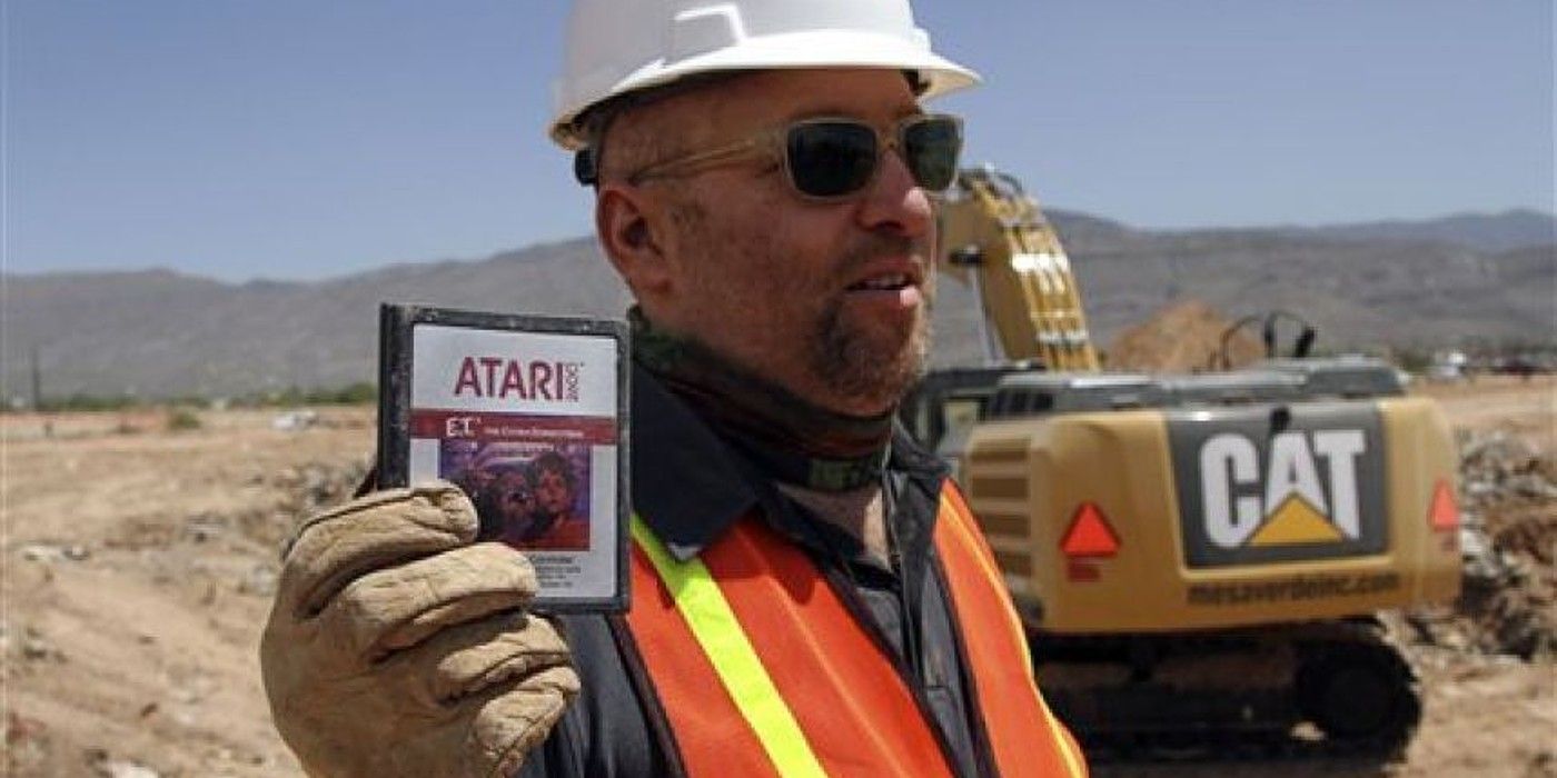 Atari Game Over film construction worker holding up ET cart at excavation site
