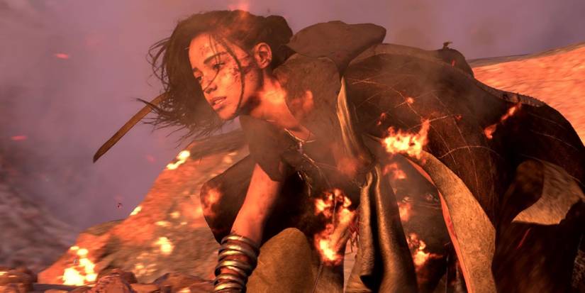 Forspoken protagonist Frey Holland on fire and battle damaged