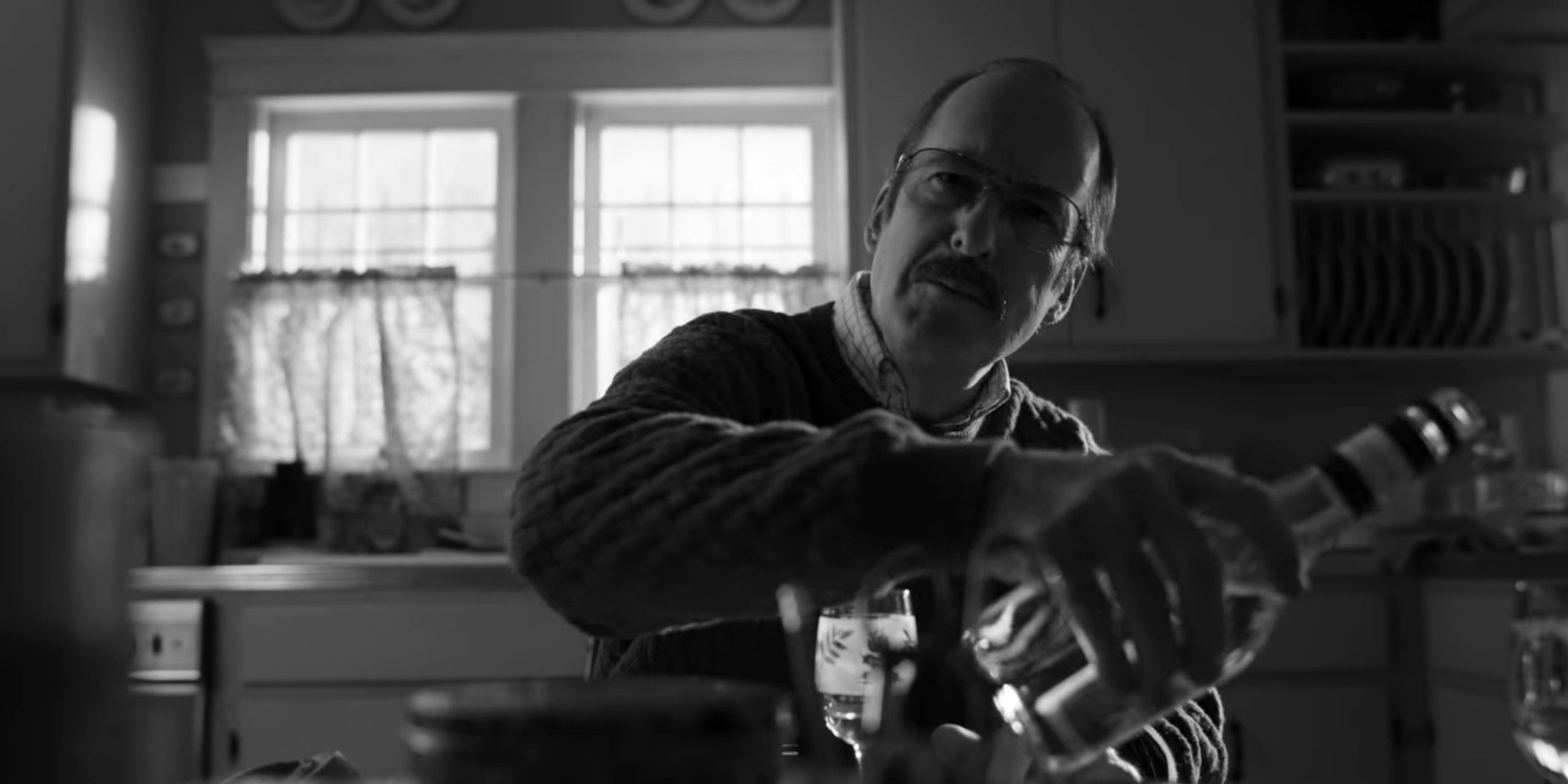 Bob Odenkirk as Gene Takovic pouring drink in Better Call Saul