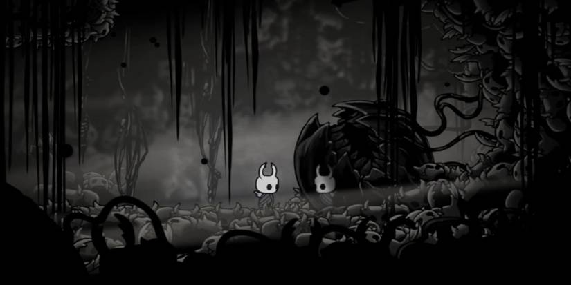 The Knight from Hollow Knight in an area of the Abyss