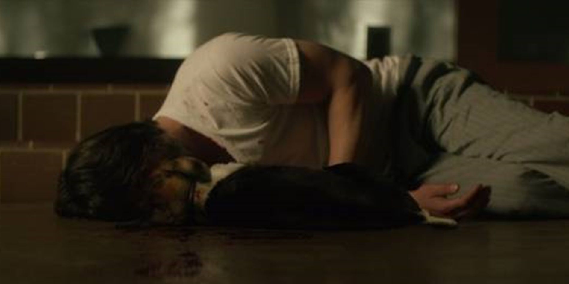 John Wick lies next to his dead dog