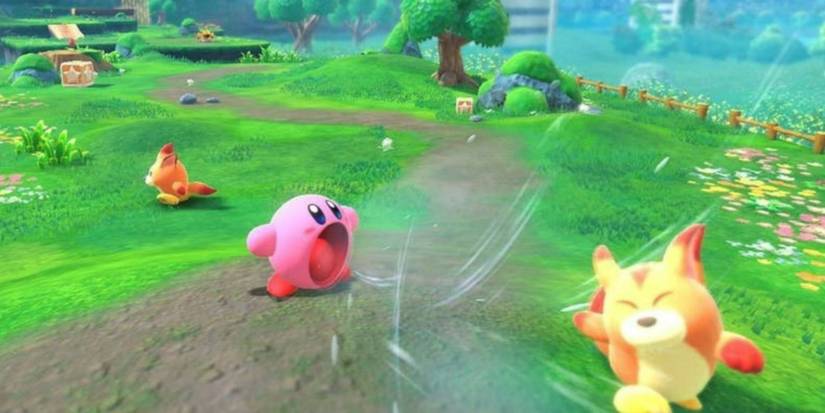 Kirby using his inhale ability on Awoofy in a green space in Forgotten Lands