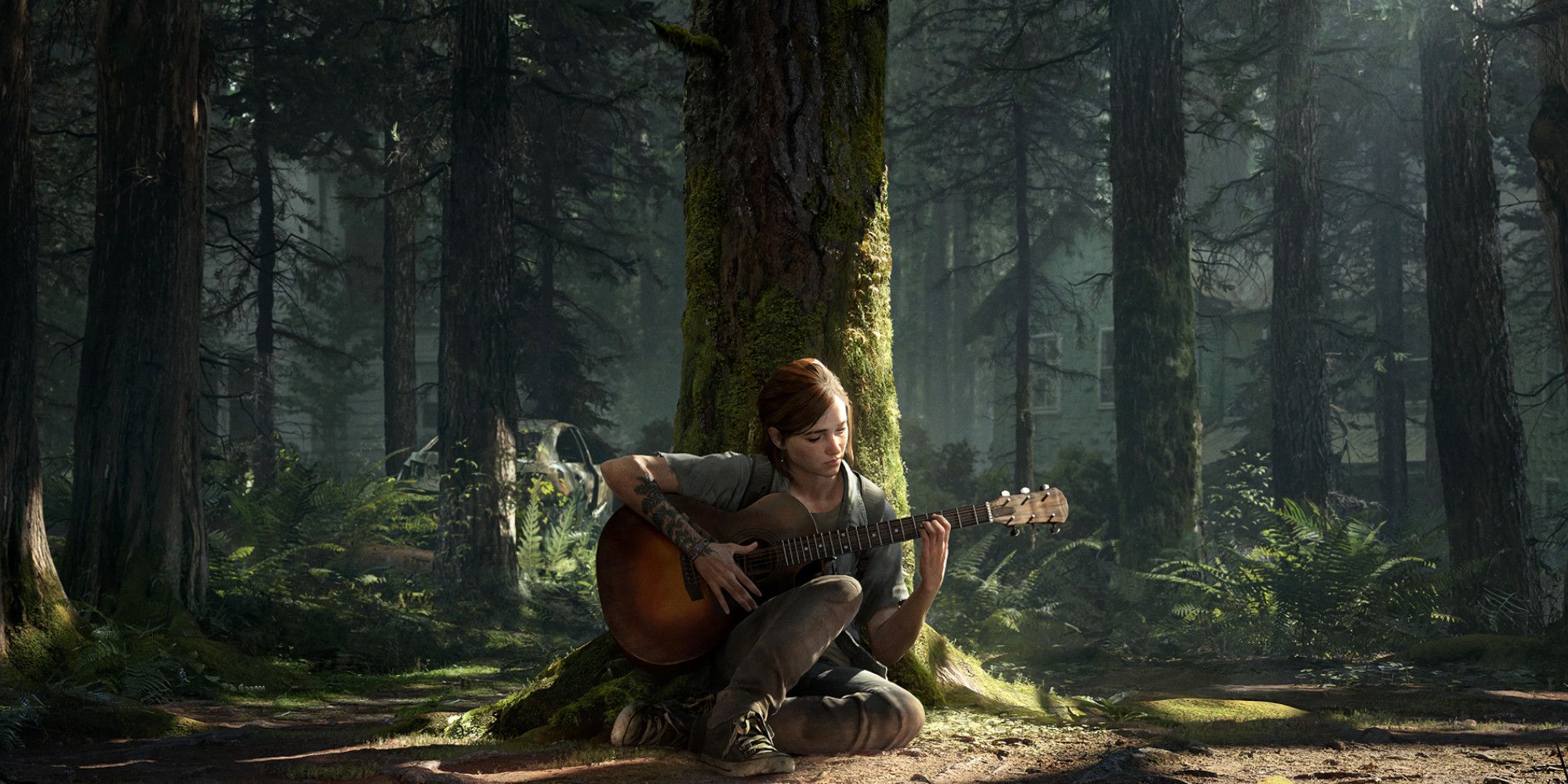 Ellie sits in front of a tree playing guitar