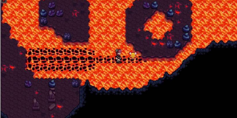 Player standing on a bridge over lava and a Lava Lurk in the Volcano Dungeon