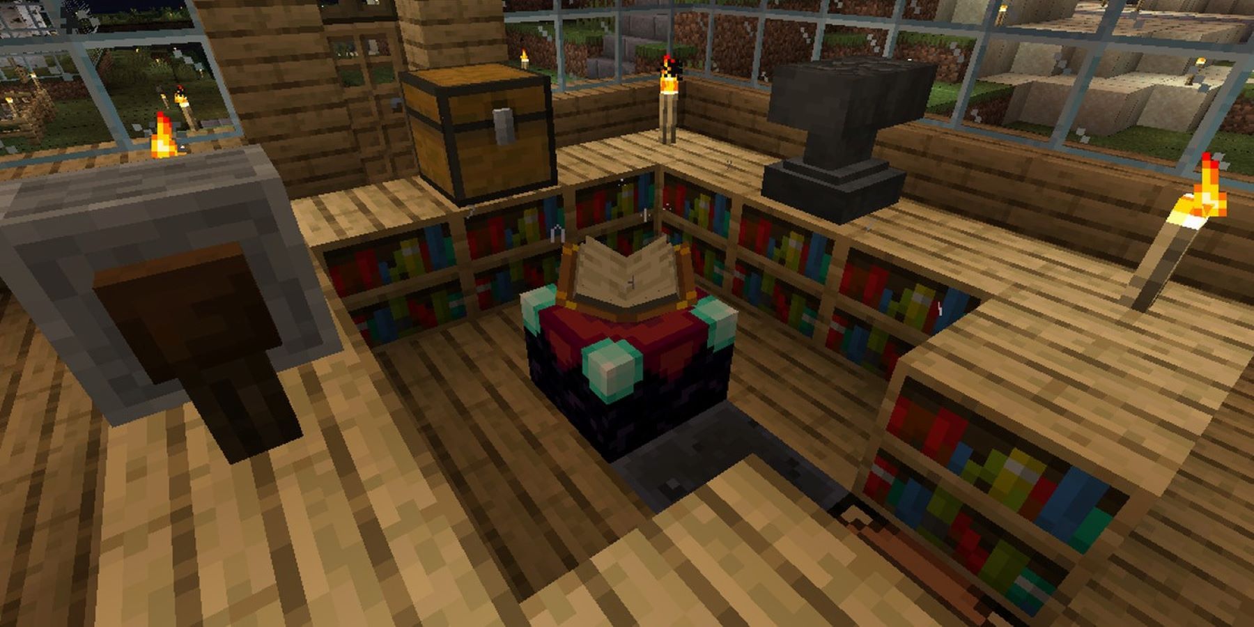 An enchanting table in Minecraft surrounded by bookshelves, an anvil, a grindstone, and a chest