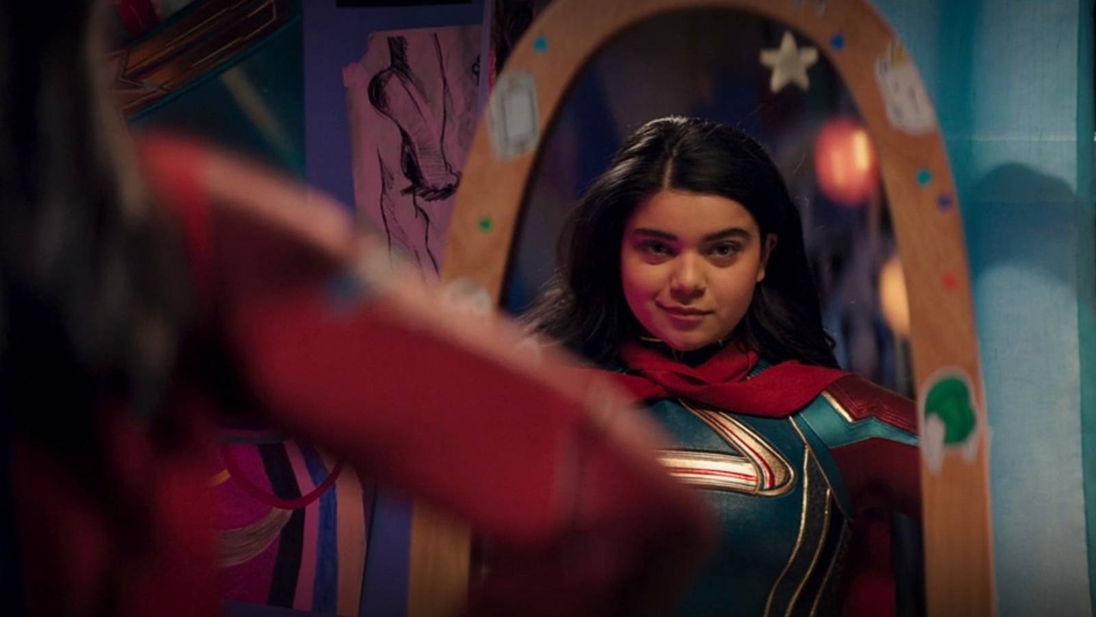 Ms. Marvel trying costume in mirror