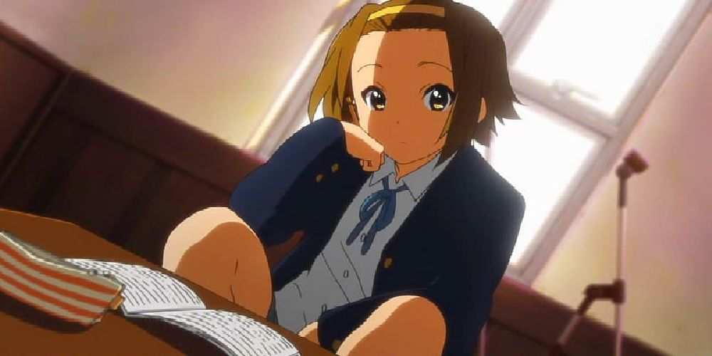 Ritsu Tainaka reading in the clubroom in the K-ON! anime