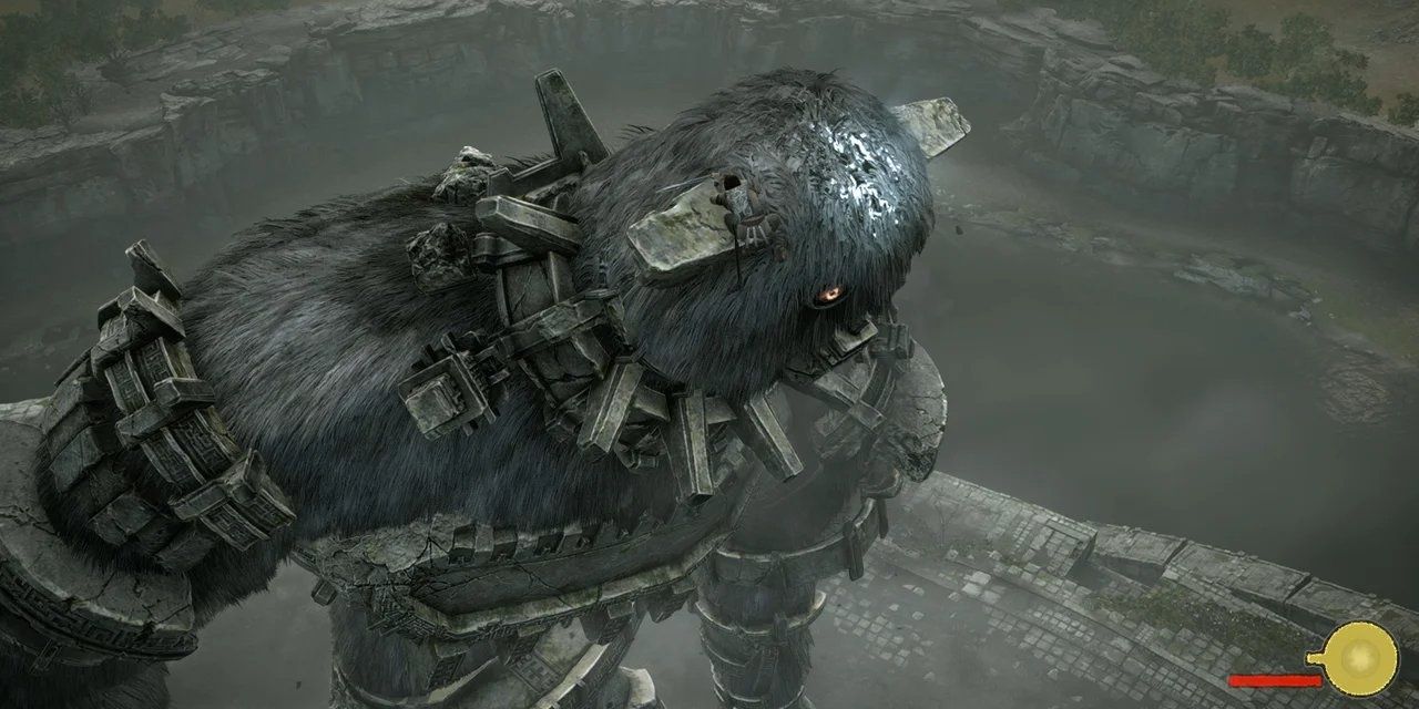 The player climbing onto the head of a large colossus in Shadow Of The Colossus
