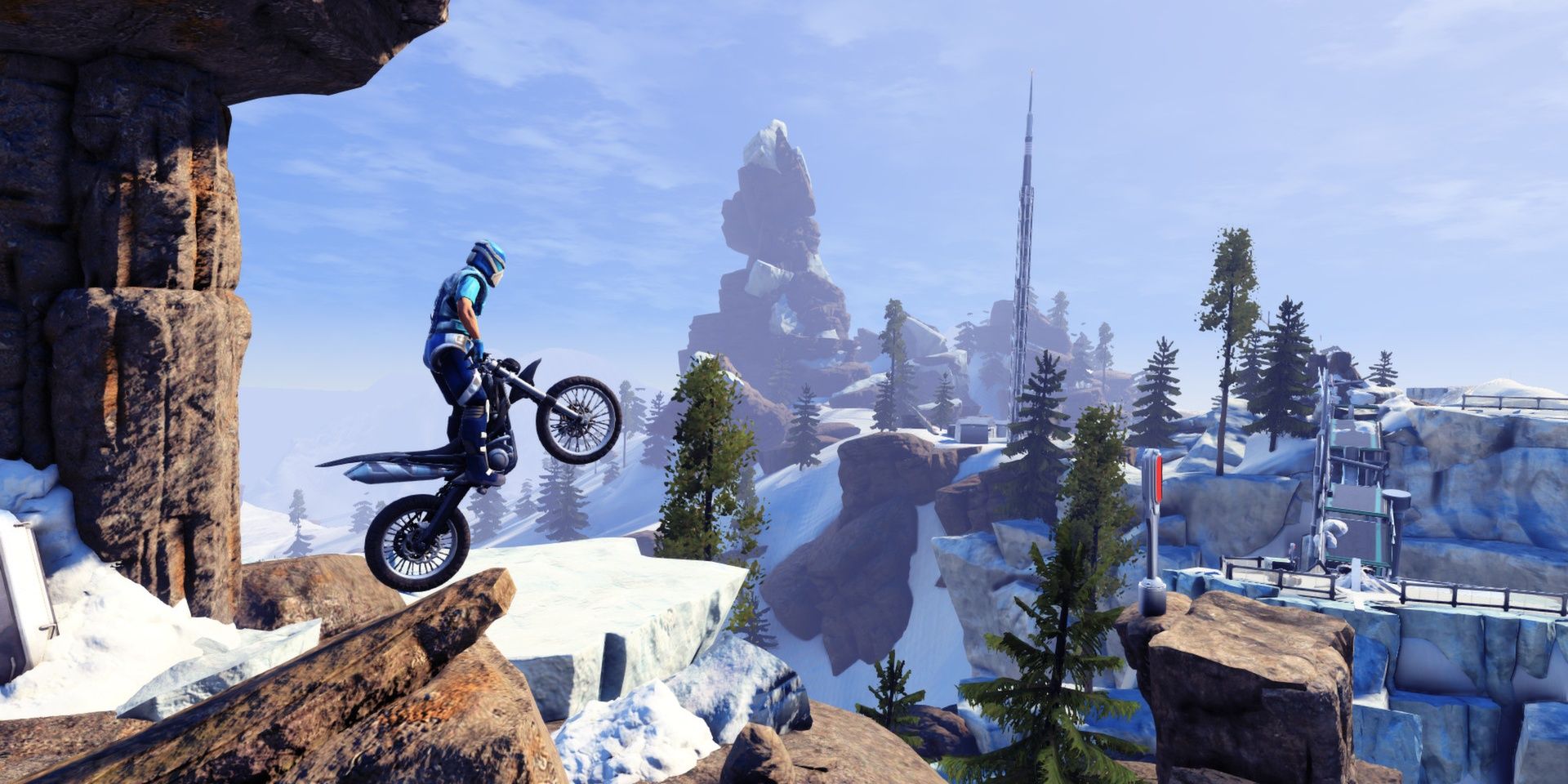 A biker driving off a cliff edge with mountains and snow in the background in Trials Fusion