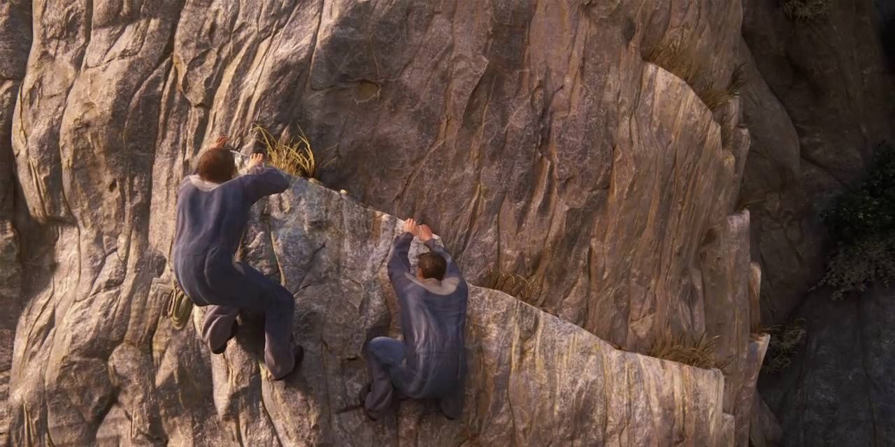Two people holding onto a ledge on the side of a cliff in Uncharted 4