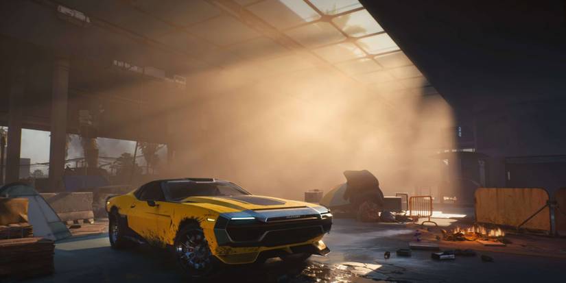 A muscle car sits in an old warehouse