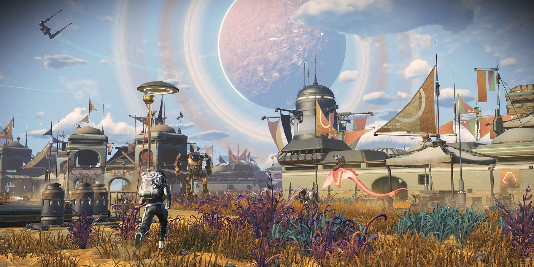 Screenshot from No Man's Sky showing the player approaching a settlment, with another planet hanging in the sky in the distance.