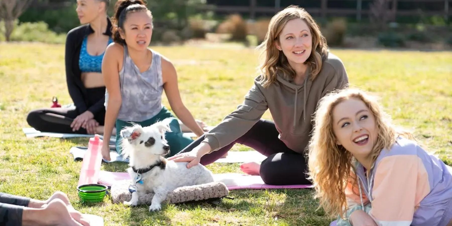 Judy Greer as Maggie on a lawn with a dog in "Good Boy" Into The Dark episode