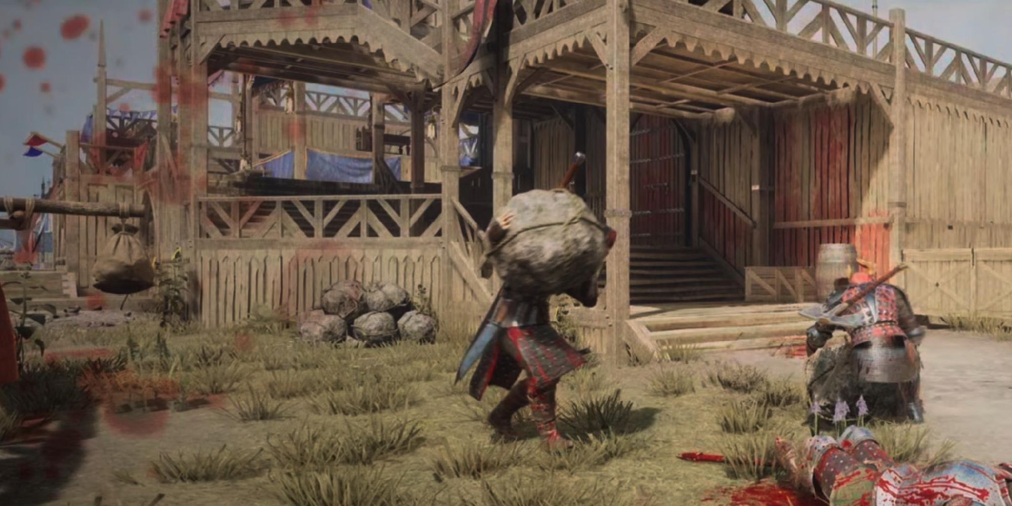 A Chivalry 2 player threatening another with a giant rock at Tournament Grounds