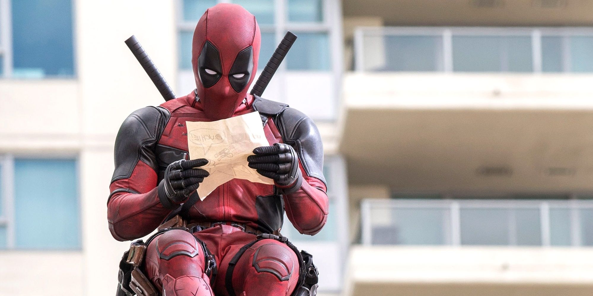 Deadpool looking at a drawing