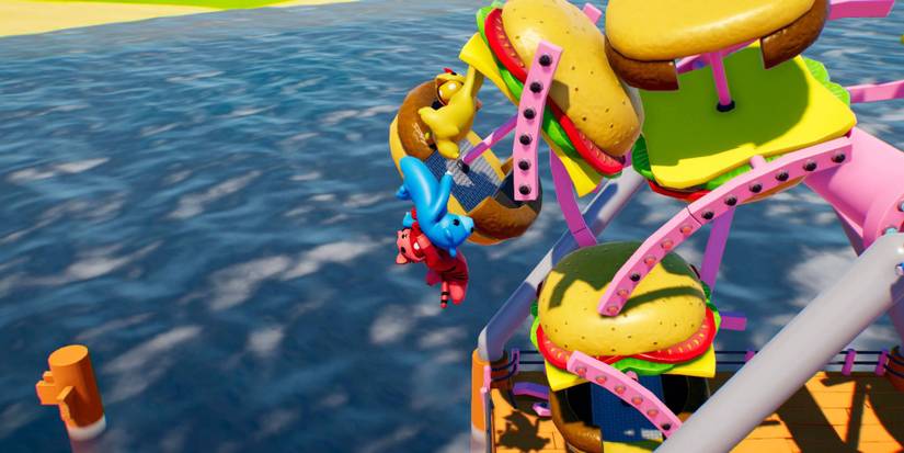 Three players hanging on to one another and a burger shaped ferris wheel mid-level in Gang Beasts