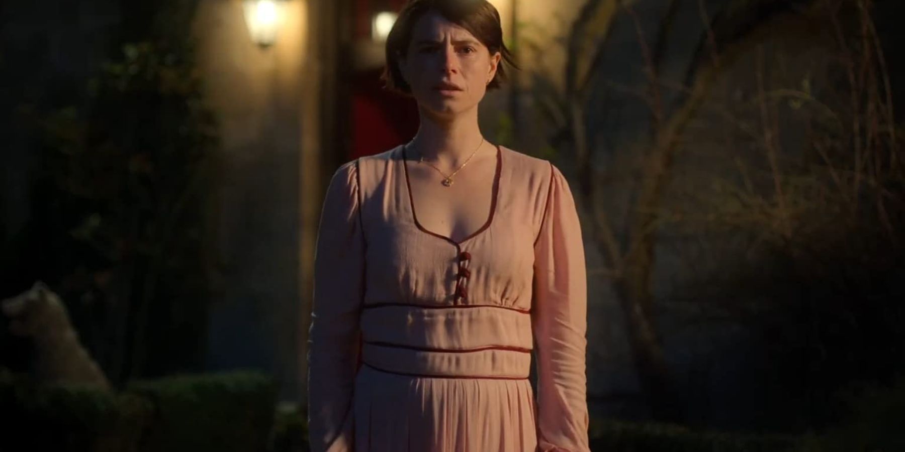 Harper (Jessie Buckley) wearing a pink dress in Men