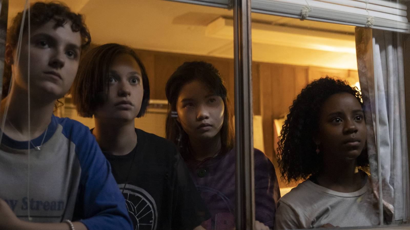 KJ, Mac, Erin and Tiff in a trailer in Paper Girls