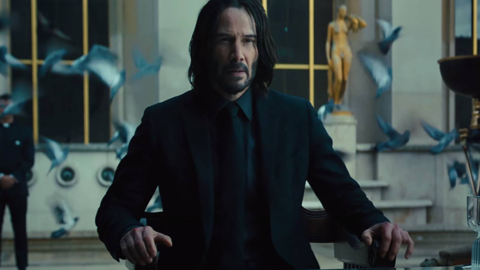 Keanu-sits-at-table-in-John-Wick-Chapter-4