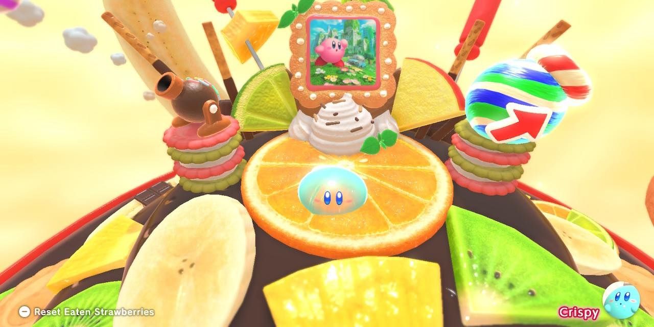 Скриншот: Кирби в образе Джелли, сидящего на дольке апельсина в Kirby