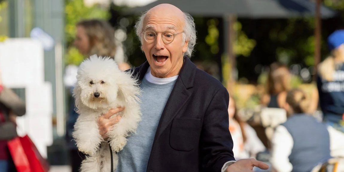 Larry holding a dog in Curb Your Enthusiasm