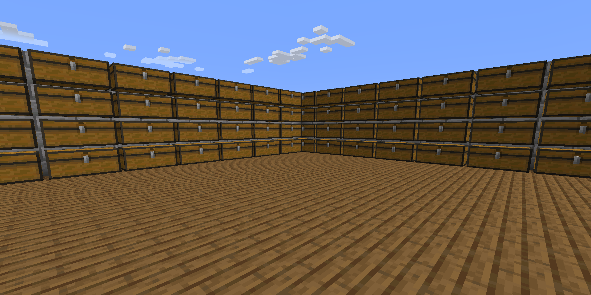 A large room in Minecraft with stacked chests and wooden floor