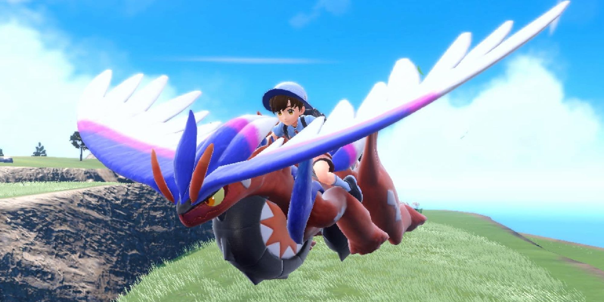A male player riding a Koraidon in glide form in Scarlet & Violet