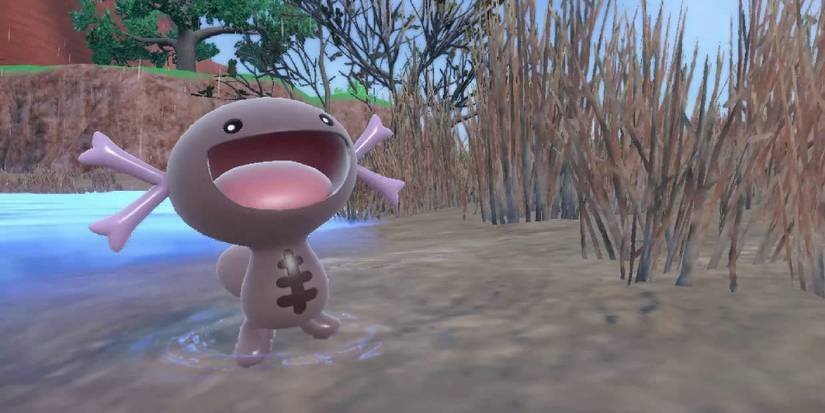 A Paldean Wooper near a muddy river in Scarlet & Violet