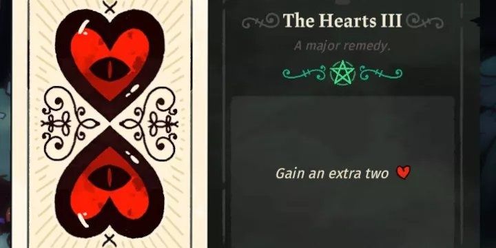 Карта Таро Hearts III из Cult of The Lamb, на ней изображены два сердца с глазом внутри.