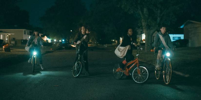 The girls ride their bikes in Paper Girls