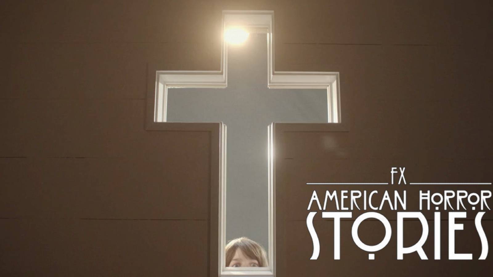 Edward (Ian Sharkey) peers through cross in American Horror Stories 