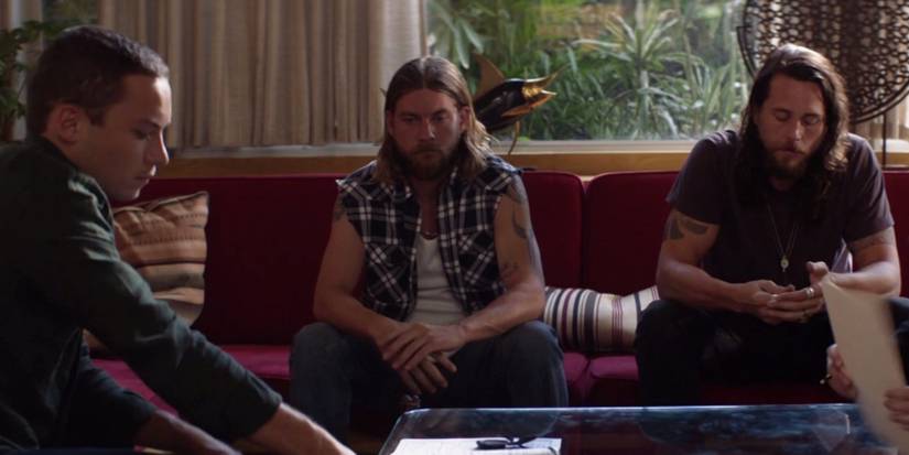 J (Finn Cole) signs documents with Deran (Jake Weary) and Craig (Ben Robson) in Animal Kingdom season 6