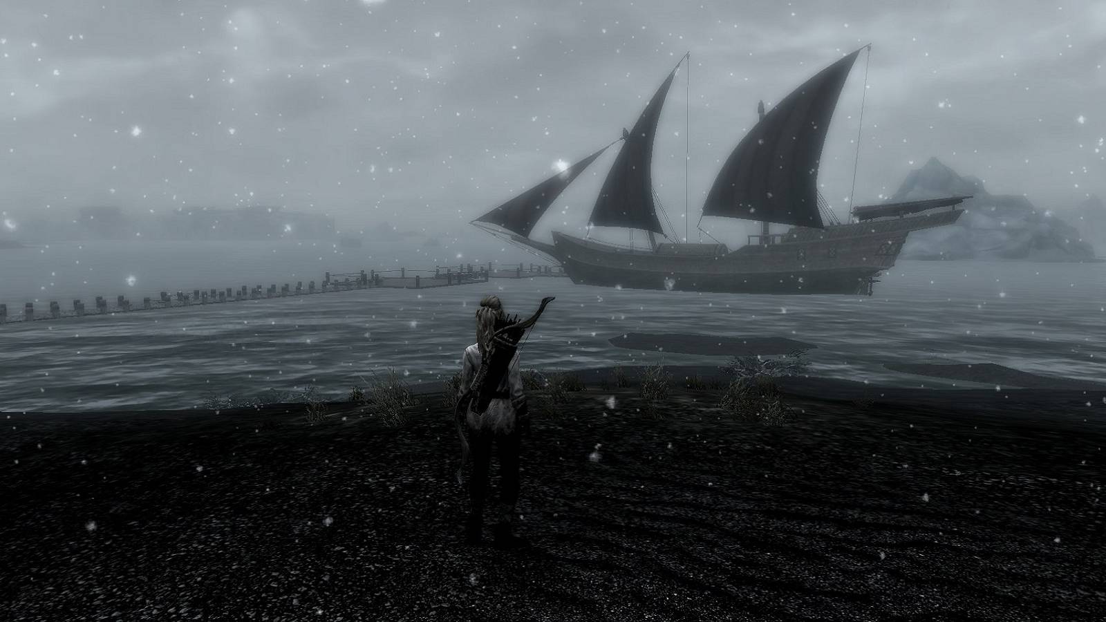 Image from Skyrim showing a character stood on a cold island, with a ship sailing by the distance.