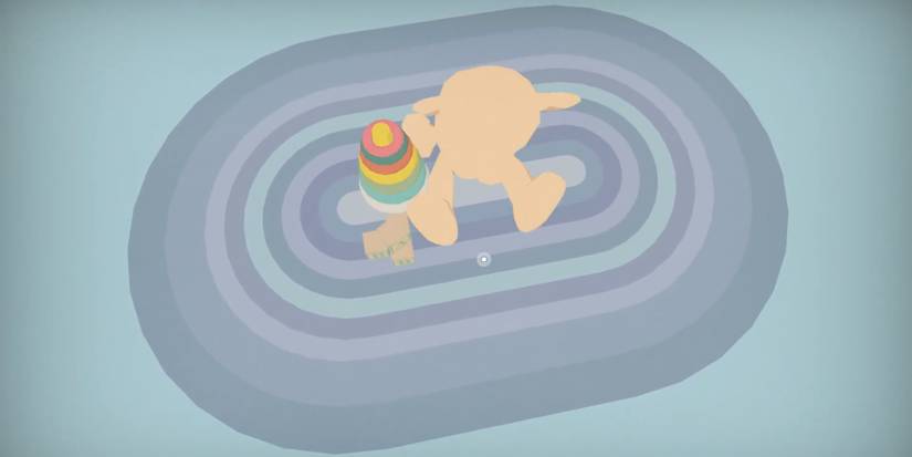 Player moves a teddy bear, alphabet blocks, and a stacked rings toy on the mat. 