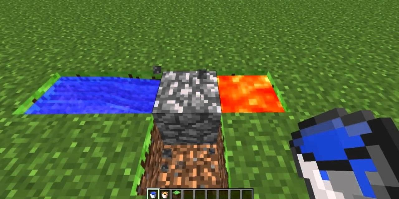 A player holding a bucket of water looking down at a Cobblestone Generator in Minecraft